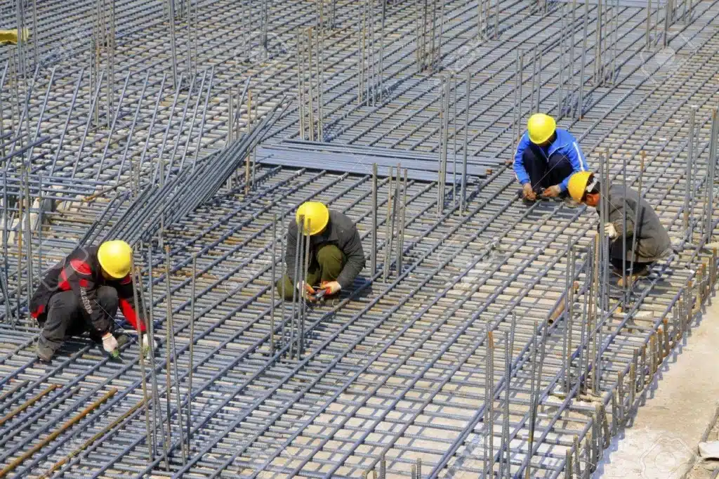 Construction engineer inspecting reinforcement steel before concrete casting
